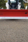 Skid steer clearing snow using Bendall hydraulic snow plow

Bendall 96” red snow plow angled to the side

Close-up of adjustable skid shoes and hydraulic fittings

Rear view of snow blade attached to skid steer

Bolt-on reversible cutting edge on Bendall plow