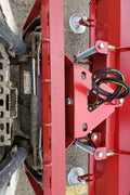 Skid steer clearing snow using Bendall hydraulic snow plow

Bendall 96” red snow plow angled to the side

Close-up of adjustable skid shoes and hydraulic fittings

Rear view of snow blade attached to skid steer

Bolt-on reversible cutting edge on Bendall plow