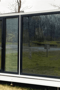 Expandable glass container house with black frame and white kitchen interior

20ft high cube glass container house on an outdoor plot

Modern prefab modular container home with large glass walls

Inside view of the container house kitchen and bathroom setup

portable luxury container home with plumbing and wiring