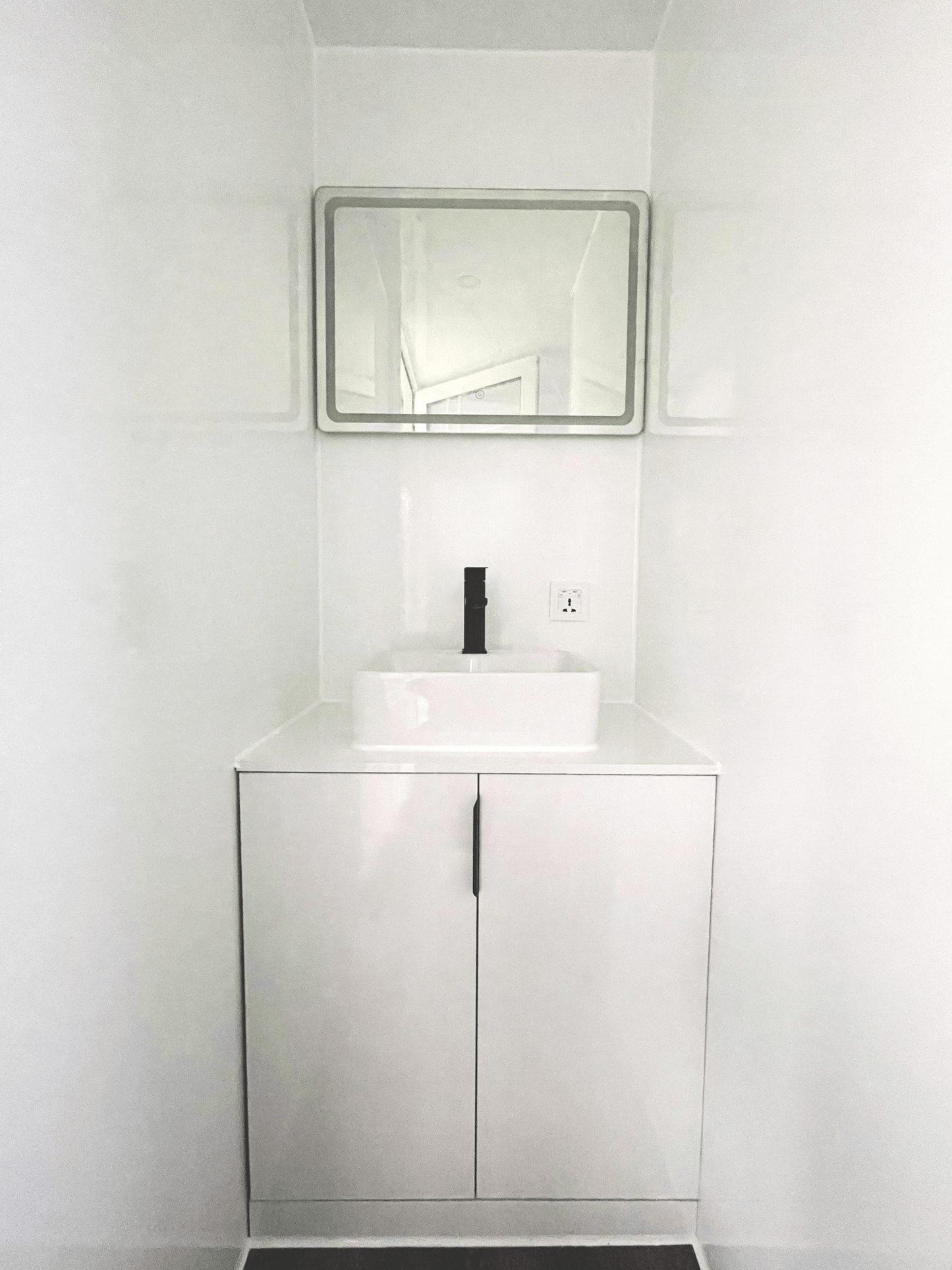 Expandable glass container house with black frame and white kitchen interior

20ft high cube glass container house on an outdoor plot

Modern prefab modular container home with large glass walls

Inside view of the container house kitchen and bathroom setup

portable luxury container home with plumbing and wiring