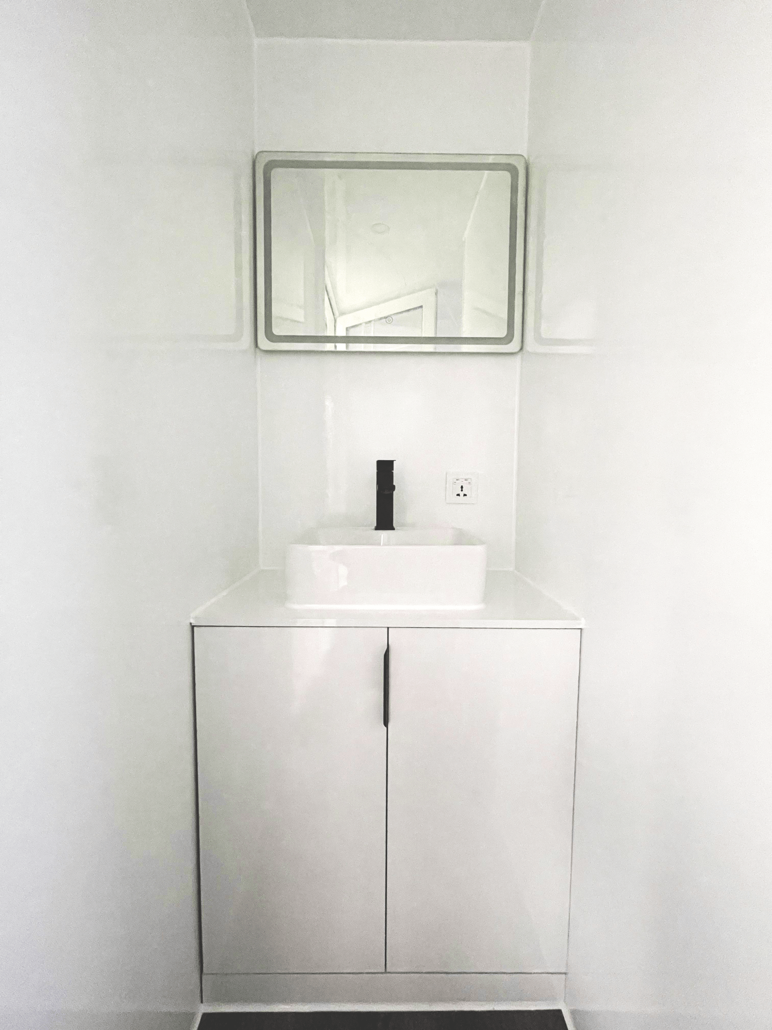 Expandable glass container house with black frame and white kitchen interior

20ft high cube glass container house on an outdoor plot

Modern prefab modular container home with large glass walls

Inside view of the container house kitchen and bathroom setup

portable luxury container home with plumbing and wiring