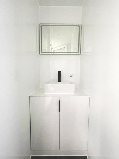 Expandable glass container house with black frame and white kitchen interior

20ft high cube glass container house on an outdoor plot

Modern prefab modular container home with large glass walls

Inside view of the container house kitchen and bathroom setup

portable luxury container home with plumbing and wiring
