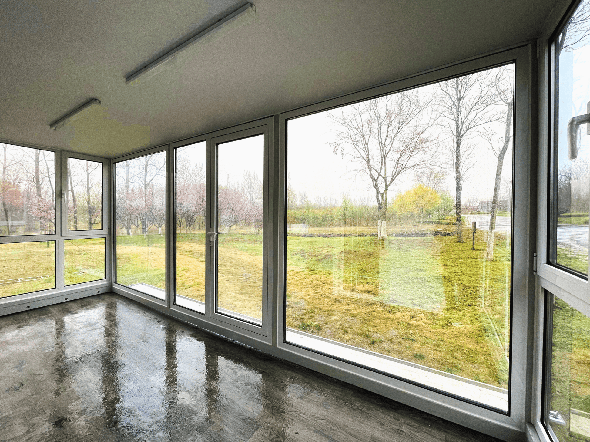 Expandable glass container house with black frame and white kitchen interior

20ft high cube glass container house on an outdoor plot

Modern prefab modular container home with large glass walls

Inside view of the container house kitchen and bathroom setup

portable luxury container home with plumbing and wiring