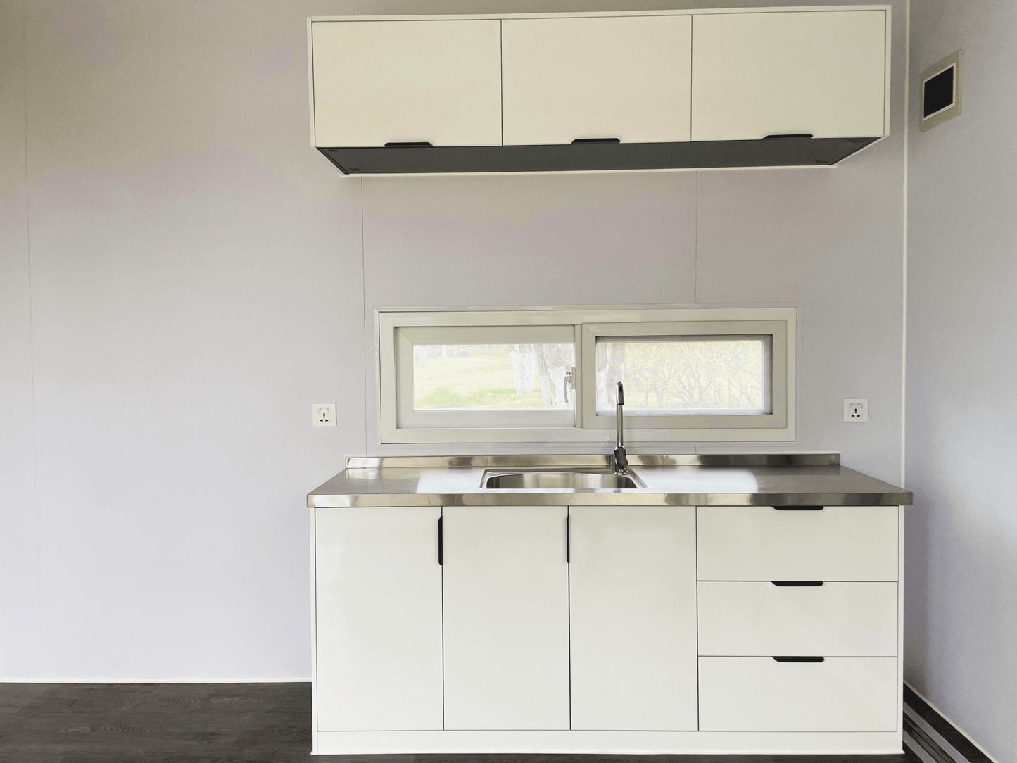 Expandable glass container house with black frame and white kitchen interior

20ft high cube glass container house on an outdoor plot

Modern prefab modular container home with large glass walls

Inside view of the container house kitchen and bathroom setup

portable luxury container home with plumbing and wiring