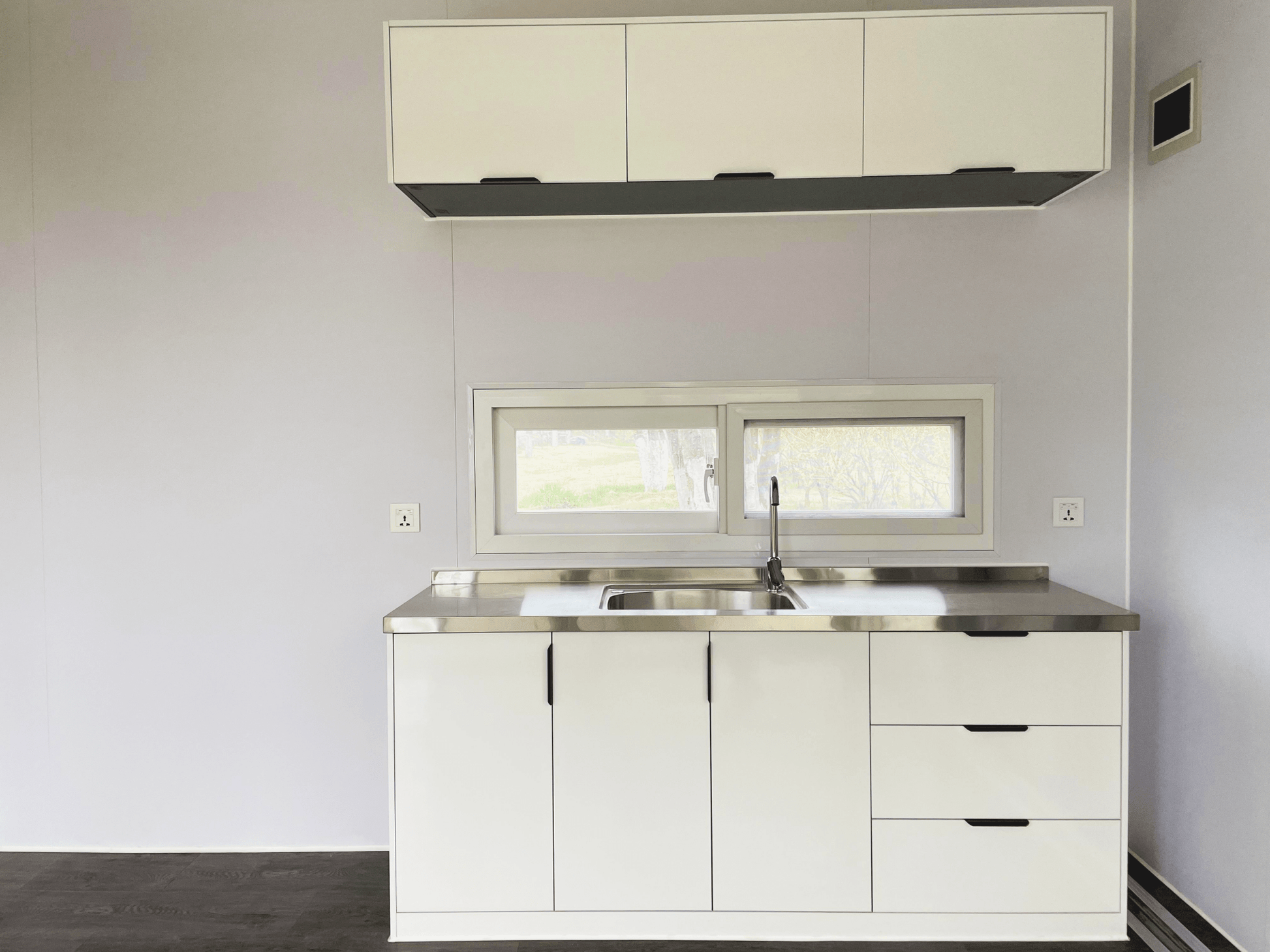 Expandable glass container house with black frame and white kitchen interior

20ft high cube glass container house on an outdoor plot

Modern prefab modular container home with large glass walls

Inside view of the container house kitchen and bathroom setup

portable luxury container home with plumbing and wiring