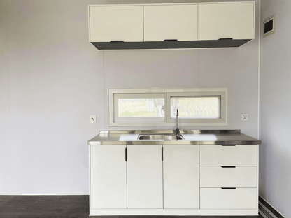Expandable glass container house with black frame and white kitchen interior

20ft high cube glass container house on an outdoor plot

Modern prefab modular container home with large glass walls

Inside view of the container house kitchen and bathroom setup

portable luxury container home with plumbing and wiring