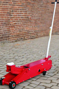 Red 20 ton hydraulic long floor jack with heavy-duty steel frame and casters

