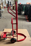 Red tire trolley cart with pneumatic wheels in garage

Heavy-duty tire dolly lifting tire set, ergonomic grip detail, welded frame close-up, tire stack in transit