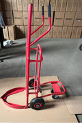 Red tire trolley cart with pneumatic wheels in garage

Heavy-duty tire dolly lifting tire set, ergonomic grip detail, welded frame close-up, tire stack in transit
