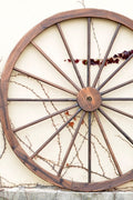 "Rustic wooden wagon wheel 48 inch for garden decor"

"Burnt wood wagon wheel leaning against a fence"

"Farmhouse yard display with decorative wooden wheels"