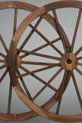 "Rustic wooden wagon wheel 48 inch for garden decor"

"Burnt wood wagon wheel leaning against a fence"

"Farmhouse yard display with decorative wooden wheels"
