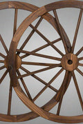 "Rustic wooden wagon wheel 48 inch for garden decor"

"Burnt wood wagon wheel leaning against a fence"

"Farmhouse yard display with decorative wooden wheels"