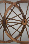 "Rustic wooden wagon wheel 48 inch for garden decor"

"Burnt wood wagon wheel leaning against a fence"

"Farmhouse yard display with decorative wooden wheels"