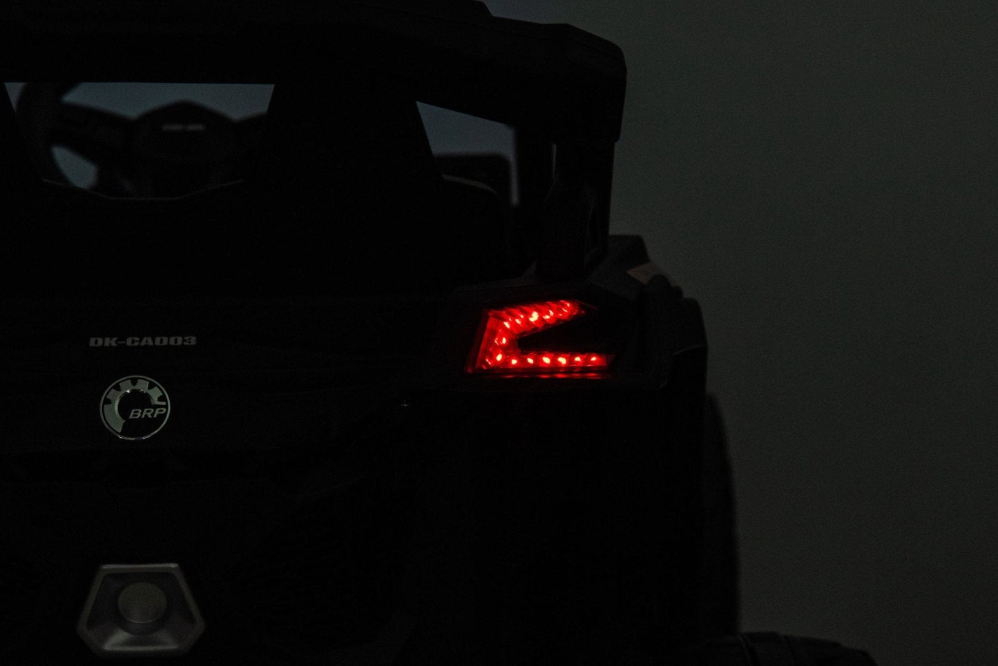 Neon Green 24V Can-Am UTV ride-on car for kids

Side view of Can-Am Maverick electric kids vehicle

Rear suspension view of 2-seater ride-on UTV

LED headlight detail on Can-Am ride-on

Kids ride-on off-road UTV in Neon Pink