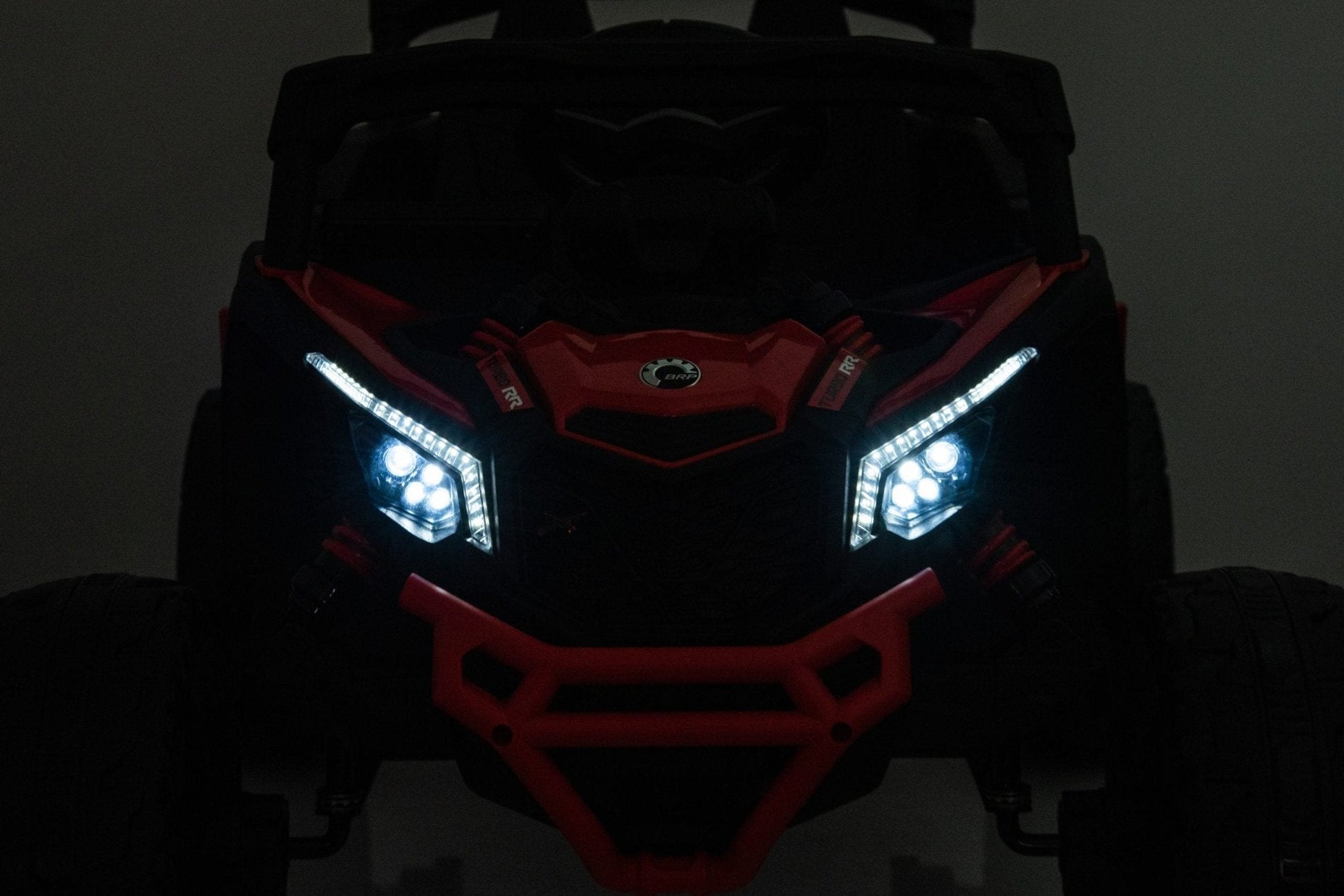 Neon Green 24V Can-Am UTV ride-on car for kids

Side view of Can-Am Maverick electric kids vehicle

Rear suspension view of 2-seater ride-on UTV

LED headlight detail on Can-Am ride-on

Kids ride-on off-road UTV in Neon Pink