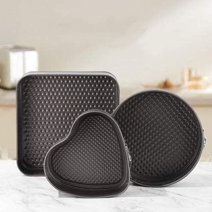 3-piece black non-stick springform pan set stacked

Close-up of leakproof buckle system and honeycomb base

Pan sizes and removable bottoms shown in open position

Full set displayed with baked cake example

Pans nested and stored compactly on kitchen counter