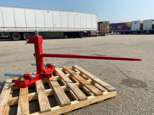 Red 3-point gooseneck hitch with bale spear mount
Tractor trailer hitch attachment with hay spear slots
Reinforced hitch frame for Conus 2 and Conus 1 spear placement
3-point trailer hitch attachment mounted on tractor
Spear holes and 2” trailer receiver on attachment frame