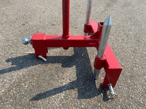 Red 3-point gooseneck hitch with bale spear mount
Tractor trailer hitch attachment with hay spear slots
Reinforced hitch frame for Conus 2 and Conus 1 spear placement
3-point trailer hitch attachment mounted on tractor
Spear holes and 2” trailer receiver on attachment frame