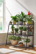 3-tier metal plant stand with potted plants in living room
Black powder-coated plant rack used indoors
Metal flower shelf displayed on outdoor patio
Sturdy decorative stand with three storage tiers
Compact garden shelf holding flowers and décor items
Close-up of black metal frame and assembly