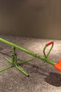 Kids spinning on green 360° seesaw in backyard
360-degree rotating seesaw with blue seats and soft handles
Outdoor seesaw with rotation and bounce action
Side view of children playing on rotating seesaw
Playground toy for toddlers and young kids