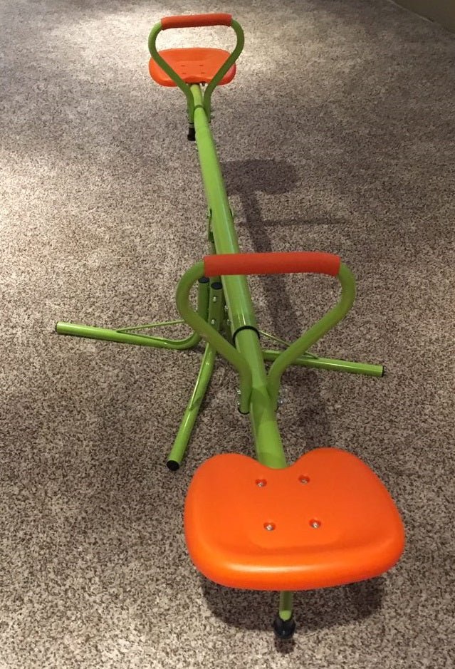 Kids spinning on green 360° seesaw in backyard
360-degree rotating seesaw with blue seats and soft handles
Outdoor seesaw with rotation and bounce action
Side view of children playing on rotating seesaw
Playground toy for toddlers and young kids
