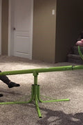 Kids spinning on green 360° seesaw in backyard
360-degree rotating seesaw with blue seats and soft handles
Outdoor seesaw with rotation and bounce action
Side view of children playing on rotating seesaw
Playground toy for toddlers and young kids