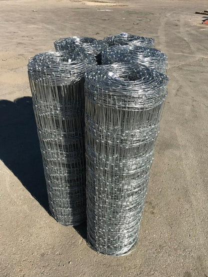 Rolled 330 FT livestock wire fence – silver steel

Close-up of barbed top and bottom wire fencing

Field wire fence rolls stacked on pallet – 4FT and 5FT

Product chart showing wire spacing and gauge specs