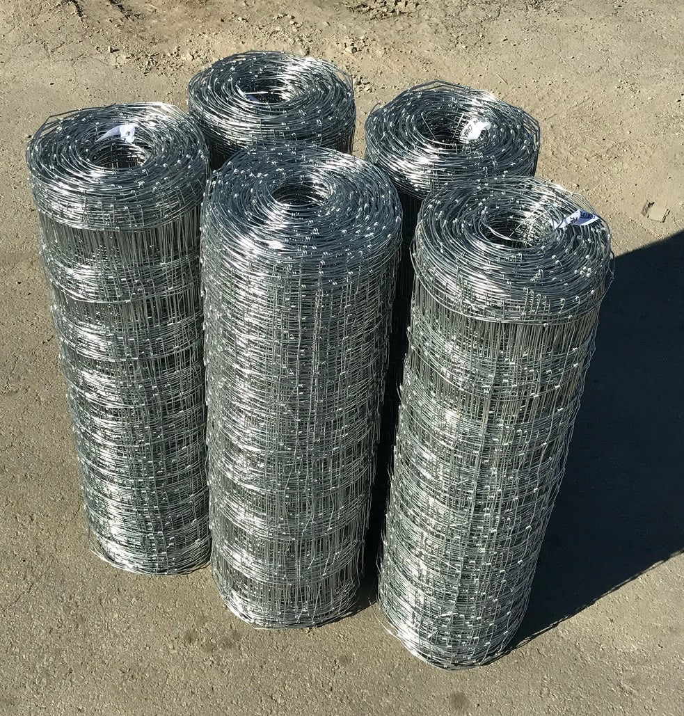 Rolled 330 FT livestock wire fence – silver steel

Close-up of barbed top and bottom wire fencing

Field wire fence rolls stacked on pallet – 4FT and 5FT

Product chart showing wire spacing and gauge specs