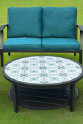 Full 4-piece patio furniture set on lawn

Close-up of swivel chair with cushions

Coffee table with ceramic top

Green loveseat in outdoor setting

Top-down view of all components