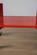 Side view of 20-gallon red portable parts washer with steel frame and drain hose