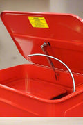Top view of parts washer basin with solvent hose, lid hinge, and filtration tray