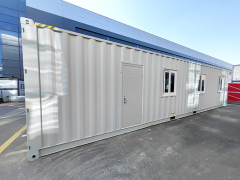 Exterior view of 40 FT insulated container office cabin

Interior layout showing vinyl flooring and workstations

TPS insulated walls and faux leather trim details

Plumbing and water system built into mobile cabin

Rear angle showing door and window design