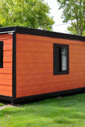 Rear angle of 3-bedroom container-style mobile home with black trim