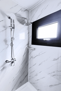 Shower unit with white tile walls and waterproof enclosure