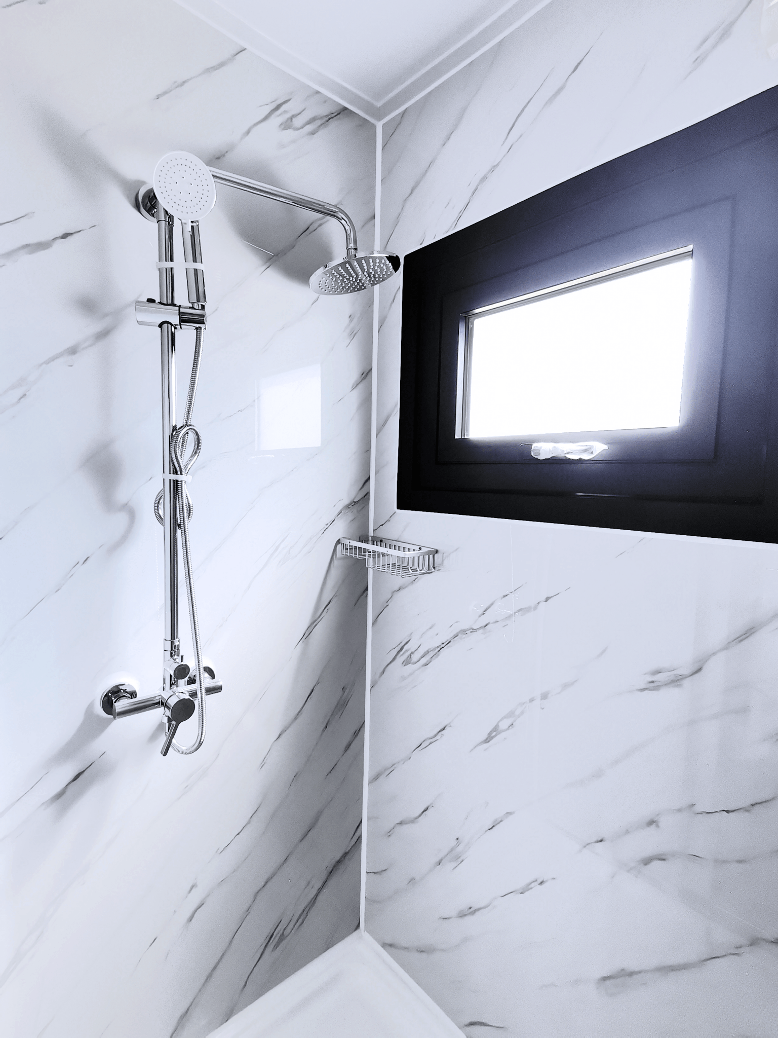 Shower unit with white tile walls and waterproof enclosure