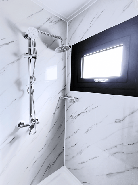 Shower unit with white tile walls and waterproof enclosure