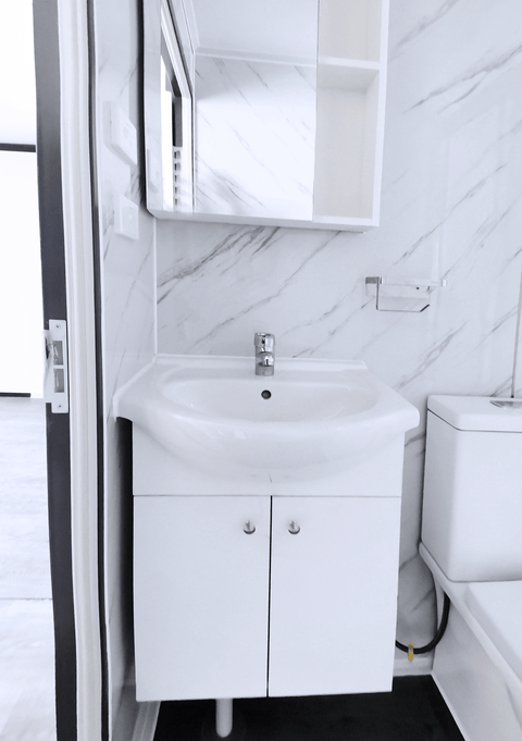 Bathroom view with mounted vanity and under-sink cabinet