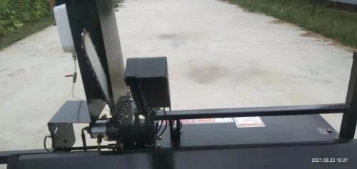 Skid steer firewood processor with 45-ton splitter attached
Log splitter with Stihl saw mounting plate
Firewood processing log cradle and splitting wedge
Heavy-duty 45-ton log processor on worksite
Operator splitting wood from skid steer seat