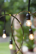 48 Ft S14 LED string lights installed at outdoor wedding
Close-up of S14 warm white LED bulb
Waterproof LED string lights cable
Full 48 ft patio string lights set with 15 bulbs
Outdoor café setting with LED string lighting