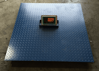 4x4 FT digital floor scale with steel checkered platform

Industrial-grade wired floor scale with LCD display

Heavy-duty 10,000 LB capacity scale with digital indicator

Digital floor scale used for freight weighing

Close-up of steel plate and load cell feet on floor scale
