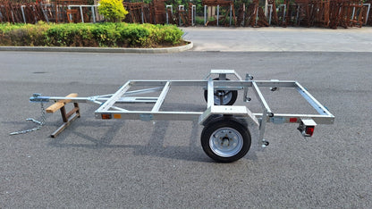 "4x8 folding aluminum utility trailer with built-in casters"

"Space-saving lightweight trailer for small vehicle hauling"

"Compact aluminum trailer folded vertically for storage"