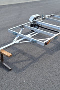 "4x8 folding aluminum utility trailer with built-in casters"

"Space-saving lightweight trailer for small vehicle hauling"

"Compact aluminum trailer folded vertically for storage"