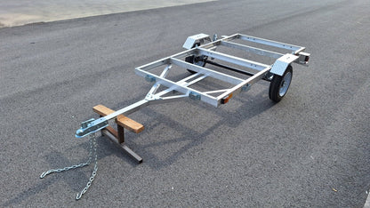 "4x8 folding aluminum utility trailer with built-in casters"

"Space-saving lightweight trailer for small vehicle hauling"

"Compact aluminum trailer folded vertically for storage"
