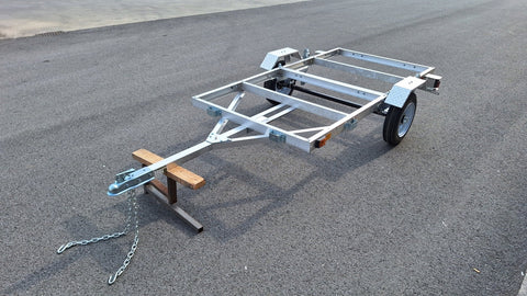 "4x8 folding aluminum utility trailer with built-in casters"

"Space-saving lightweight trailer for small vehicle hauling"

"Compact aluminum trailer folded vertically for storage"