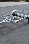 "4x8 folding aluminum utility trailer with built-in casters"

"Space-saving lightweight trailer for small vehicle hauling"

"Compact aluminum trailer folded vertically for storage"
