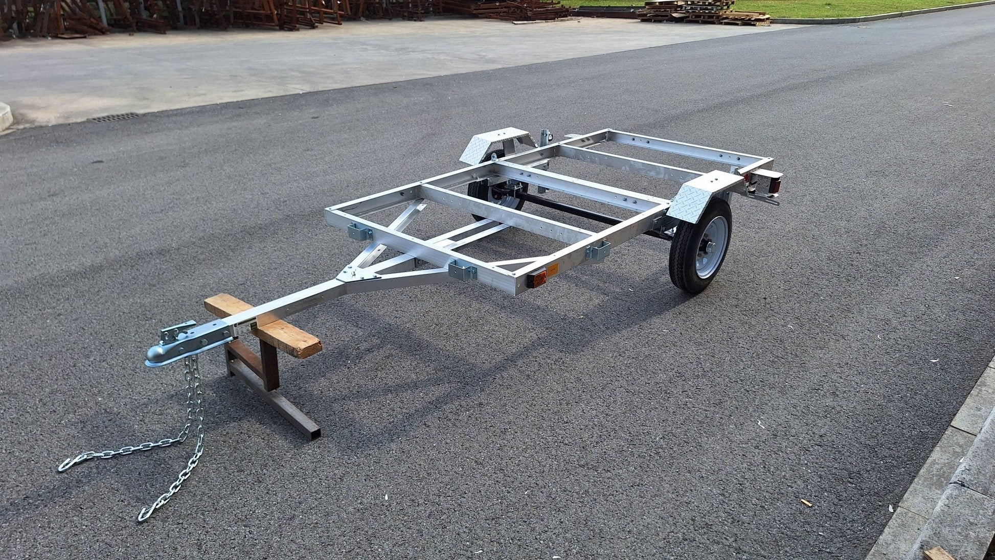 "4x8 folding aluminum utility trailer with built-in casters"

"Space-saving lightweight trailer for small vehicle hauling"

"Compact aluminum trailer folded vertically for storage"