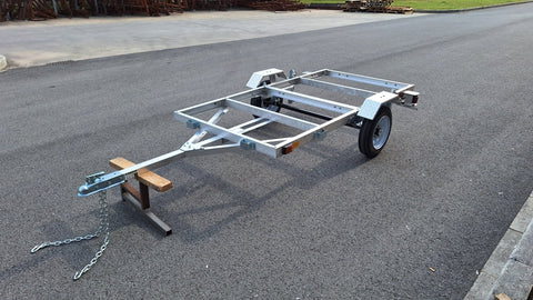 "4x8 folding aluminum utility trailer with built-in casters"

"Space-saving lightweight trailer for small vehicle hauling"

"Compact aluminum trailer folded vertically for storage"