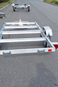 "4x8 folding aluminum utility trailer with built-in casters"

"Space-saving lightweight trailer for small vehicle hauling"

"Compact aluminum trailer folded vertically for storage"