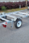 "4x8 folding aluminum utility trailer with built-in casters"

"Space-saving lightweight trailer for small vehicle hauling"

"Compact aluminum trailer folded vertically for storage"