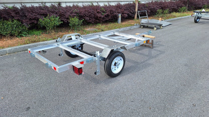 "4x8 folding aluminum utility trailer with built-in casters"

"Space-saving lightweight trailer for small vehicle hauling"

"Compact aluminum trailer folded vertically for storage"